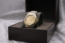 Angled view of Gucci 8040M two-tone watch presented in a brown box.