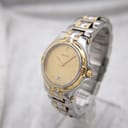 Front-angled view of the Gucci 8040M watch on a stand, showing its champagne dial.