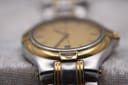 Close-up of the two-tone lug area with the engraved Gucci G logo.
