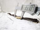 Digital caliper measuring the watch case height (lug-to-lug), displaying a precise reading of 35.48mm.
