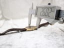 Digital caliper measuring the watch case width, displaying a precise reading of 26.82mm.