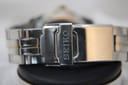 Extreme close-up of the Seiko signed deployant clasp on the two-tone stainless steel bracelet.