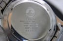 Close-up of the polished stainless steel case back, showing Seiko branding, water resistance, model number 8F32-0079, and serial 082098.