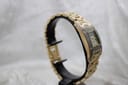 Alternative side view of the Ingersoll Diamond watch on a stand, highlighting the gold-tone bracelet and clasp.