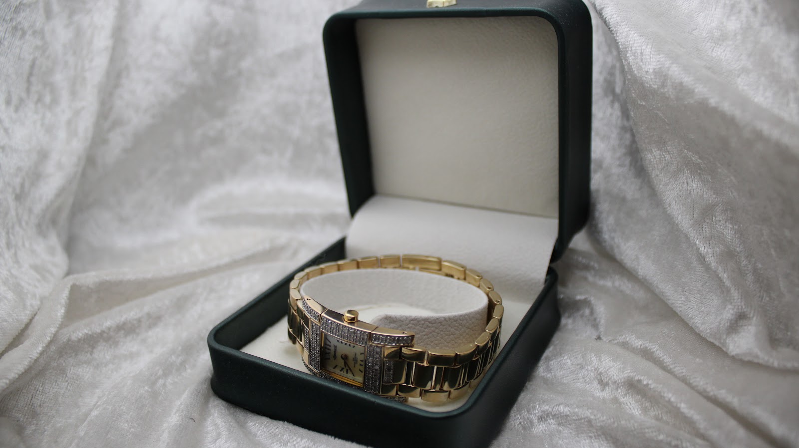 The Ingersoll Diamond watch presented inside an open dark green watch box with a cream interior.