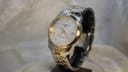 Front face view of Tissot PR 100 quartz watch with silver dial and Roman numerals.