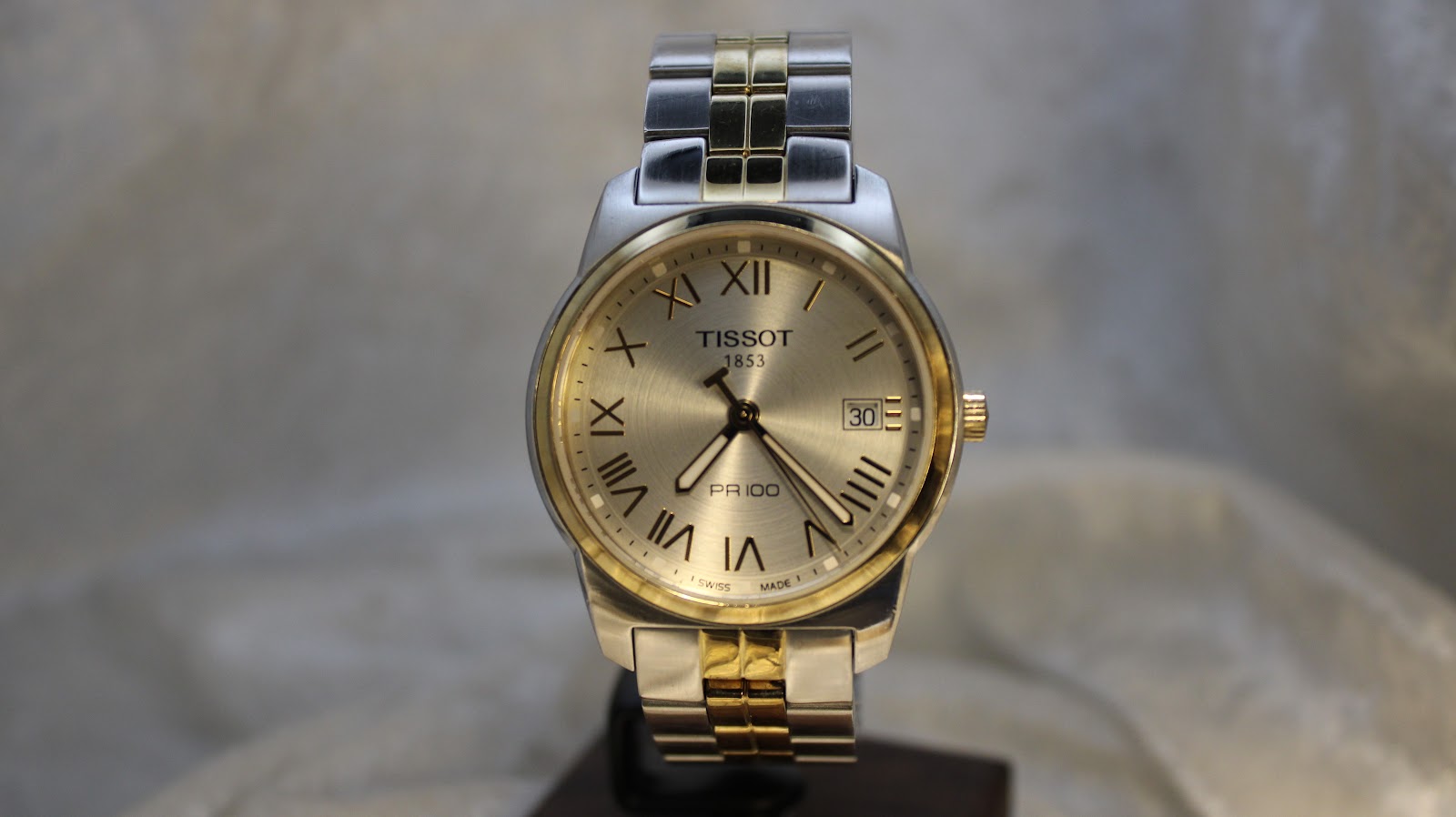 Close-up of the original Tissot two-tone stainless steel bracelet and signed clasp.