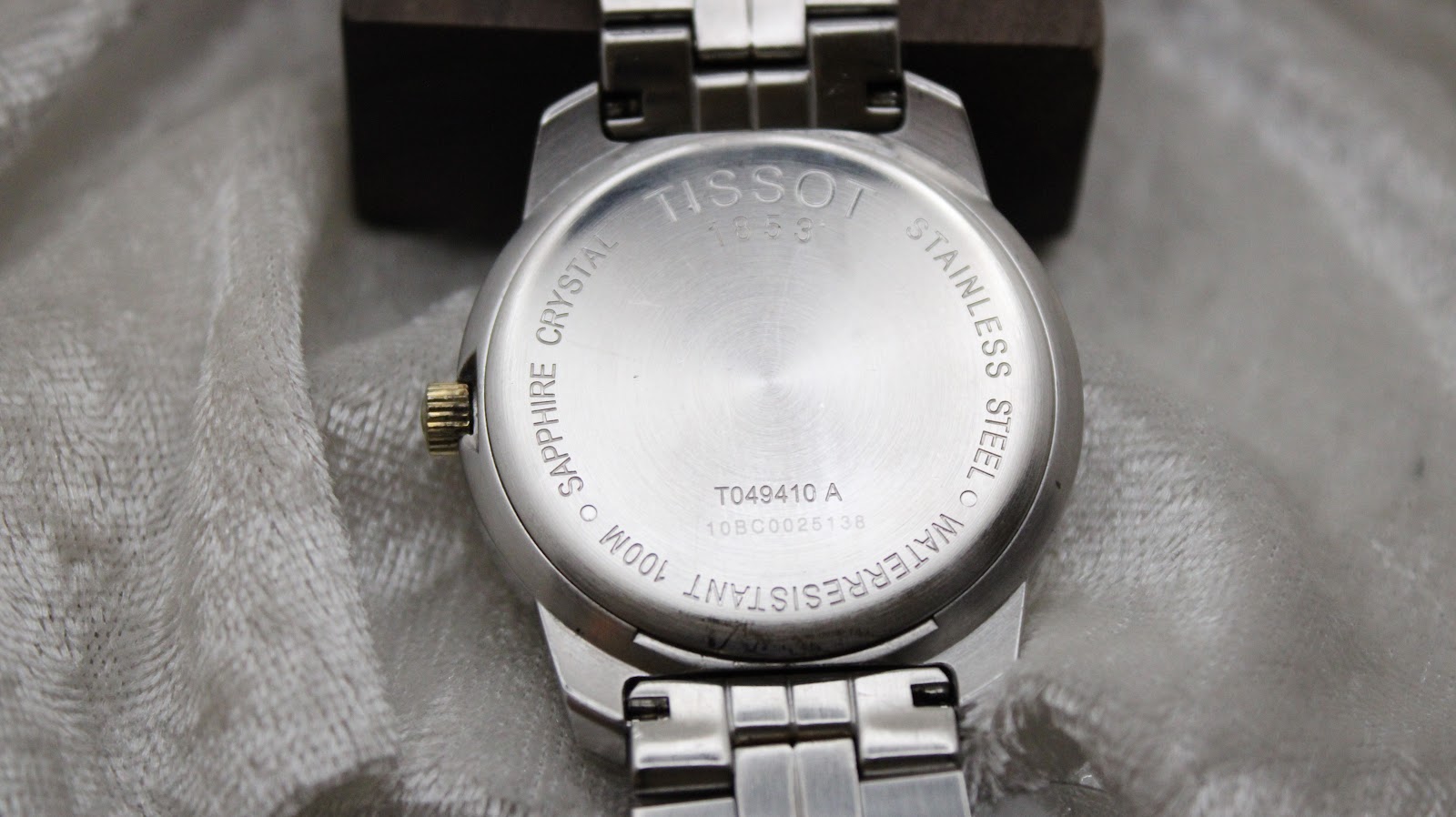 Rear view of the Tissot PR 100 stainless steel case back.