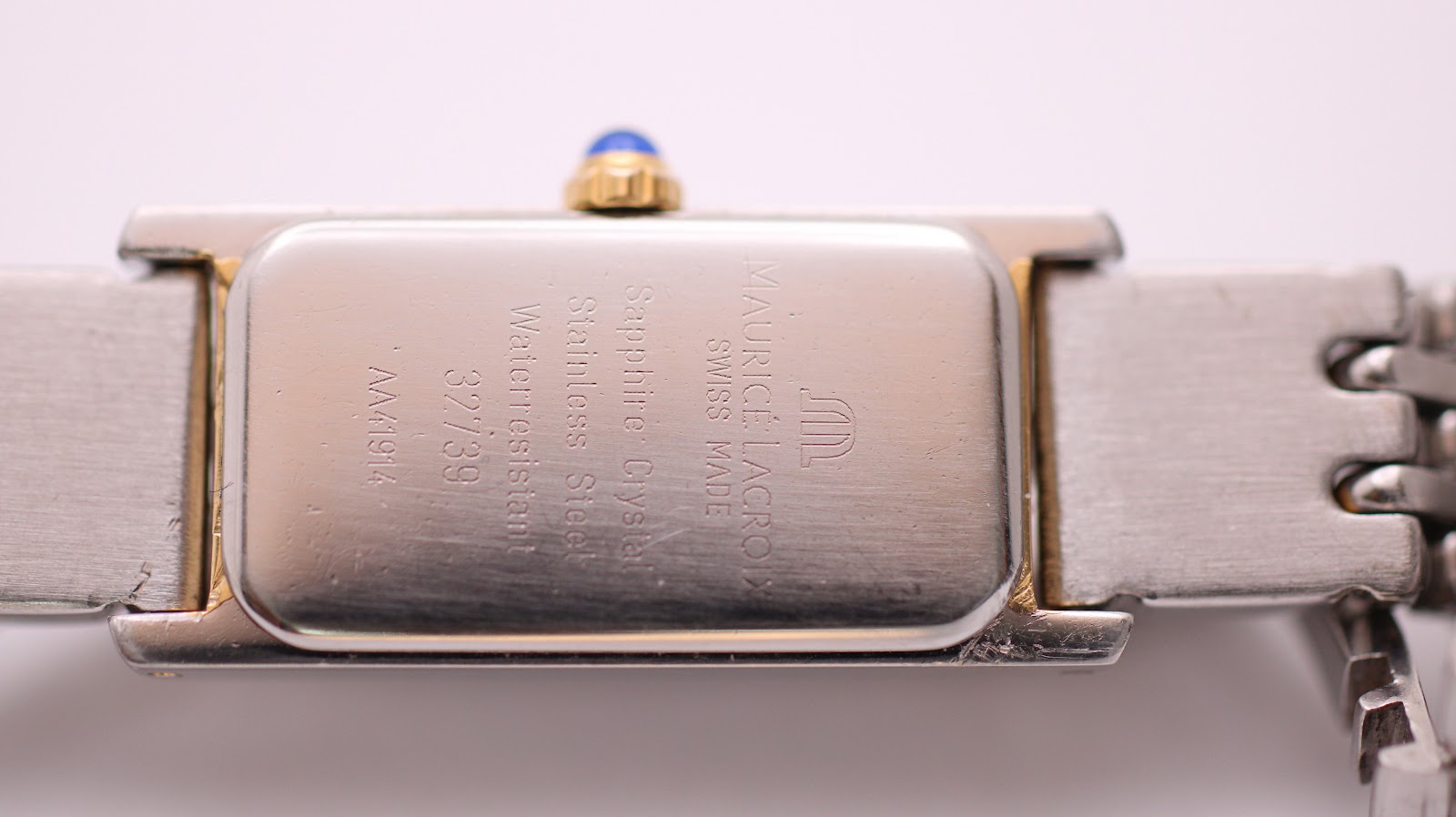 Close-up of the watch case back showing 'Maurice Lacroix Swiss Made', 'Sapphire Crystal', 'Stainless Steel', 'Waterresistant', model 32739, and reference AA41914 engravings.