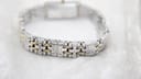 Close-up of the two-tone bracelet's curved underside, showing the alternating silver and gold-tone links and their polished finish.