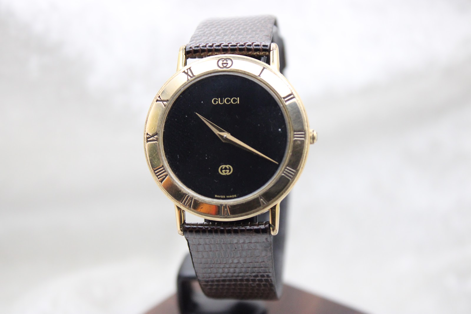 The Gucci 3000M watch displayed on a stand, direct front view, for a clear presentation.