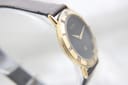 Another angled side view of the Gucci 3000M, showing the sleek lines of the gold-tone case.