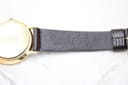 Close-up of the watch strap's interior, showing the embossed 'Genuine LEATHER' marking.