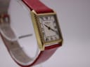 Direct front view of the rectangular Raymond Weil Genève watch, showcasing its cream dial with black Roman numeral indices and hands, framed by the gold-tone case.
