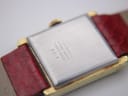 Close-up of the brushed stainless steel case back of the Raymond Weil watch, engraved with "STAINLESS STEEL BACK SWISS MADE 651".