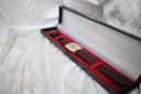 The Junghans watch resting in a black presentation box with a red velvet interior.