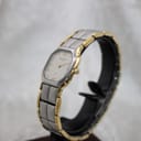 Front-right view of the Favre-Leuba Genève ladies' two-tone quartz watch on a black display stand.