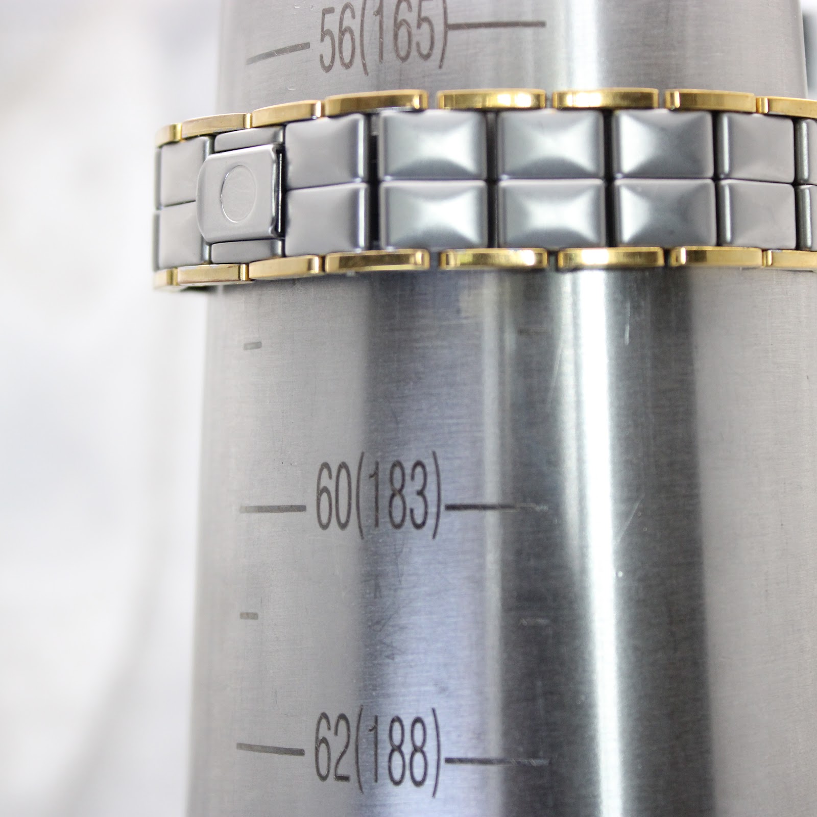 Watch bracelet on a wrist sizing cone, indicating a circumference of approximately 16.5cm (165mm).