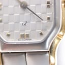Extreme close-up of the watch dial texture, showing the 'SWISS MADE' text at 6 o'clock and the subtle checkered pattern.