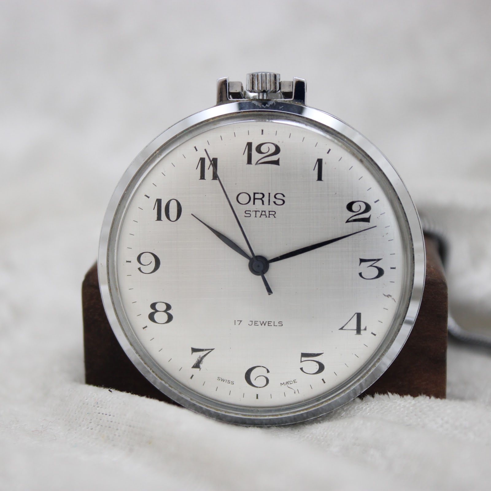 Oris pocket watch's polished side case and crown detail.