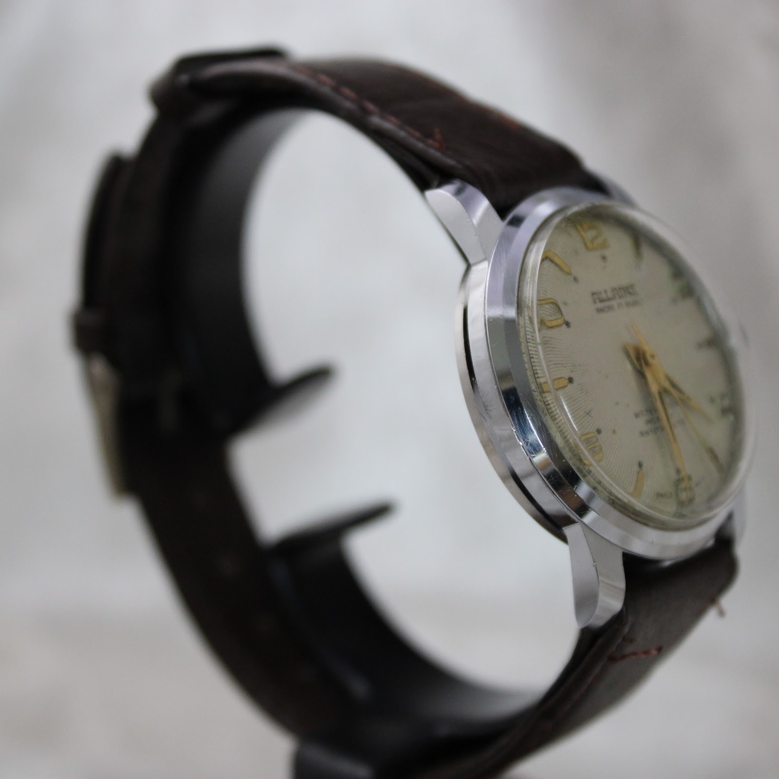 Side profile of Allaine watch showing chrome-plated case and crown details