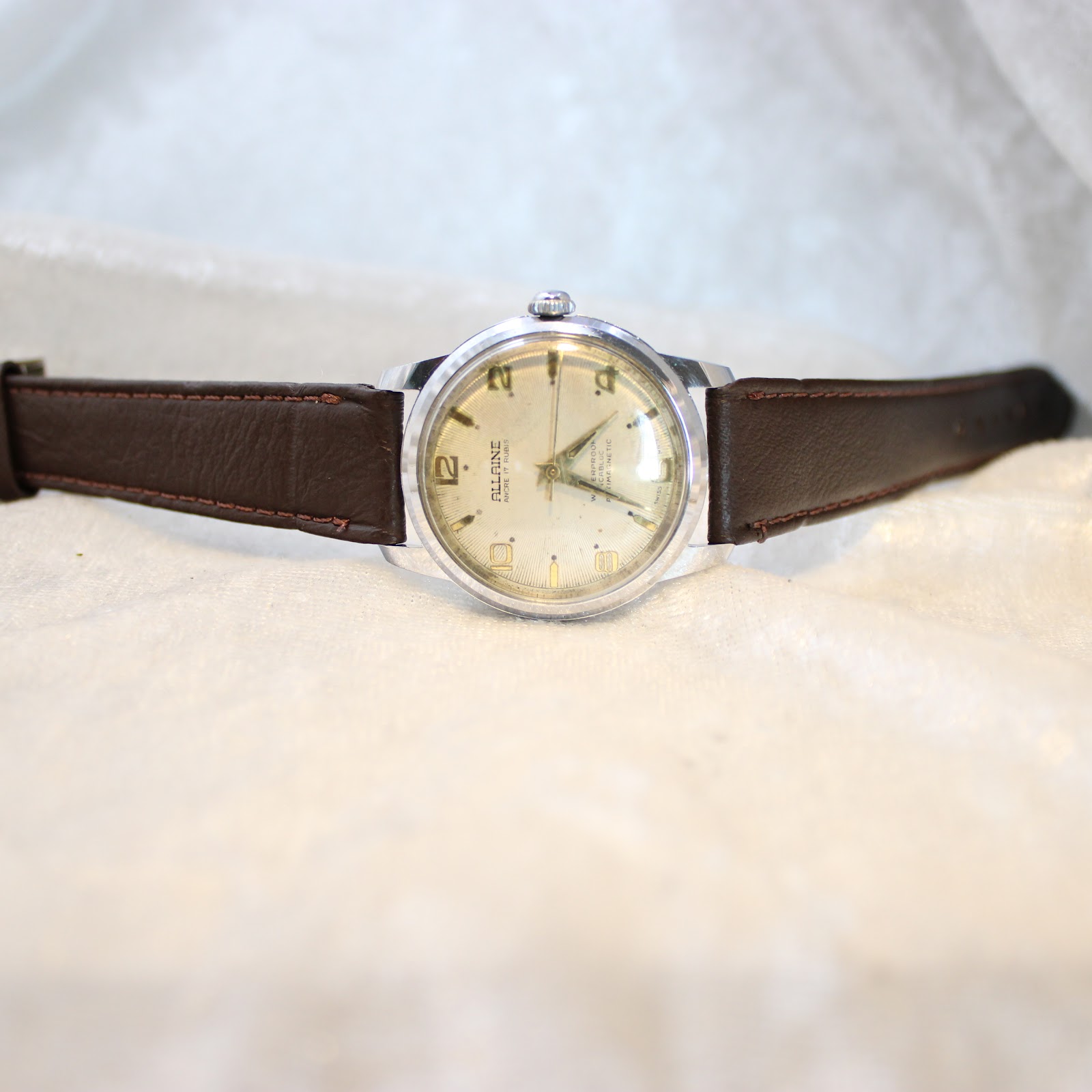 Detailed shot of textured champagne dial with gold-tone numerals and indices