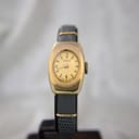 Side profile of the gold-plated Oris watch case and domed acrylic crystal.