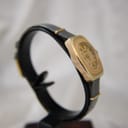 Detail of the black leather strap and pin buckle of the Oris watch.