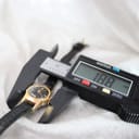 Digital caliper measuring the case of the vintage Oris watch, displaying a width of 18.8mm.
