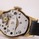 Detailed close-up of the manual wind mechanical movement, clearly showing 'SEVEN 7 JEWELS' and 'ORIS WATCH CO SWISS' engravings.