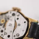 Another close-up perspective of the watch's manual wind movement, revealing the intricate gears and 'SEVEN 7 JEWELS' inscription.