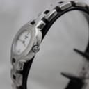 Close-up of the Tissot G330 watch crown, clearly showing the 'T' logo engraved on it.