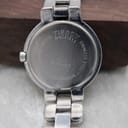 Detailed view of the Tissot G330 watch case back, engraved with "TISSOT SINCE 1853", model G330 QKS-BC, and water resistance information.