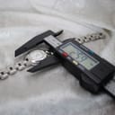 Digital caliper measuring the case diameter of the Tissot G330, displaying a precise reading of 25.9mm.