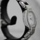 Angled side view of the Tissot G332 watch, highlighting the polished finish of the oval case and the integrated stainless steel bracelet.
