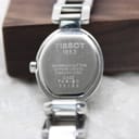 Close-up of the Tissot G332 watch case back engraving, detailing 'TISSOT 1853', 'WATER RESISTANT 30M', 'SAPPHIRE CRYSTAL', 'STAINLESS STEEL', and model 'G332 TKR-BC 55199'.