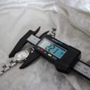 A digital caliper measuring the Tissot G332 watch case, displaying a precise width of 22.1mm.
