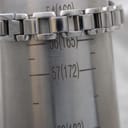 Close-up of the Tissot G332 watch's stainless steel bracelet wrapped around a wrist sizing gauge, indicating a wrist circumference of approximately 160mm.