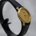 Close-up of the Tissot-signed buckle on the black leather strap.