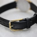 Full view of the watch on its black leather strap, showing overall presentation.