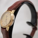 Side profile of the Tissot watch showing the recessed electronic push crown.