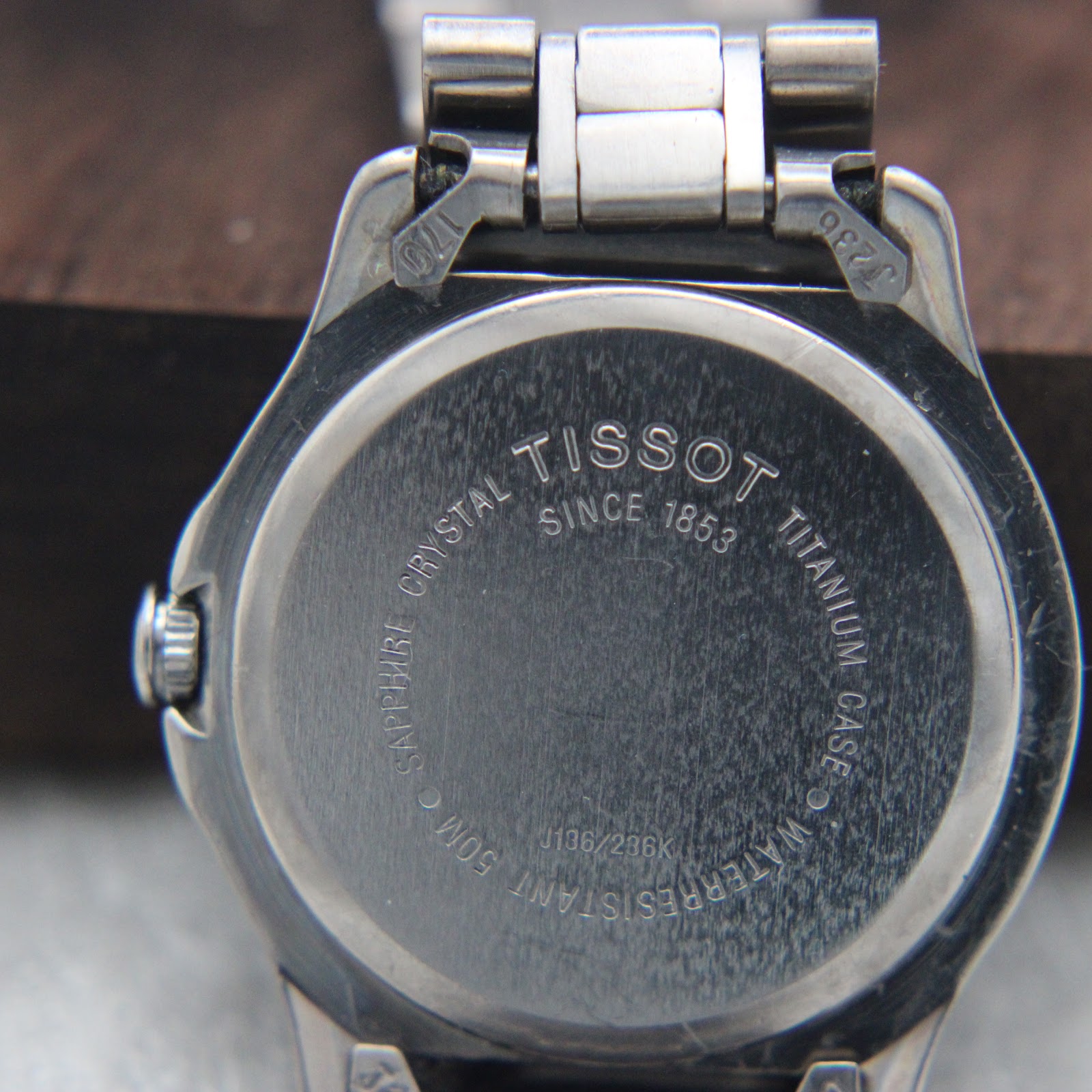 Detail shot of the Tissot PR 50 silver dial with black baton indices