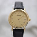 Front view of the Tissot C225K watch showing the champagne dial, gold-tone stick indices, and black leather strap, against a light background.