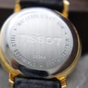 Close-up of the watch case back, showing 'TISSOT', 'C225K', 'STAINLESS STEEL', 'MINERAL GLASS', and 'WATERRESISTANT 30M' engravings.