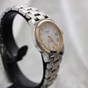 Side profile view of the Tissot PR 50 women's watch, highlighting the two-tone bracelet and case design.