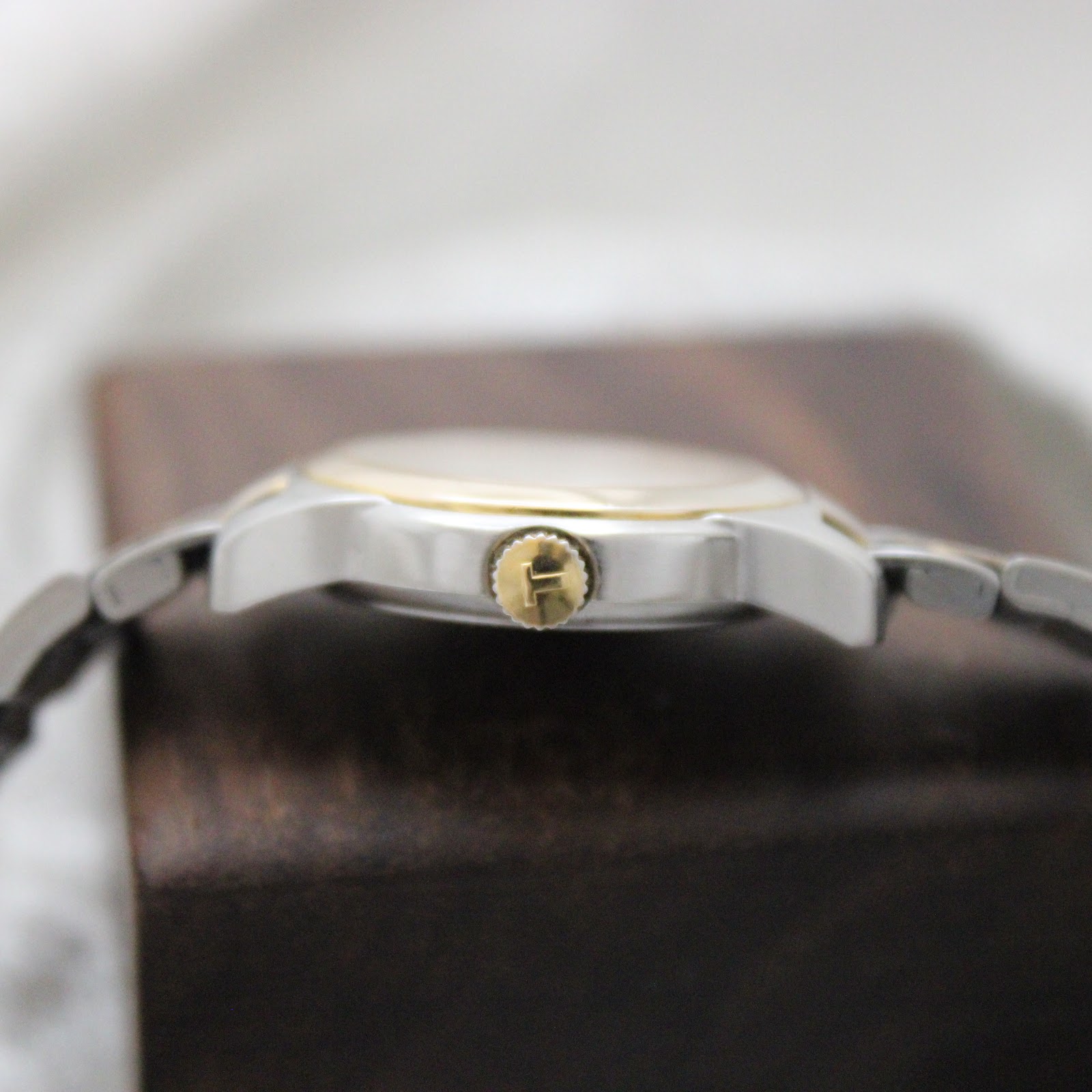 Side view of the Tissot PR 50 case, displaying the gold-tone crown with Tissot logo.