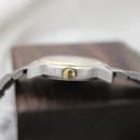 Side view of the Tissot PR 50 case, displaying the gold-tone crown with Tissot logo.