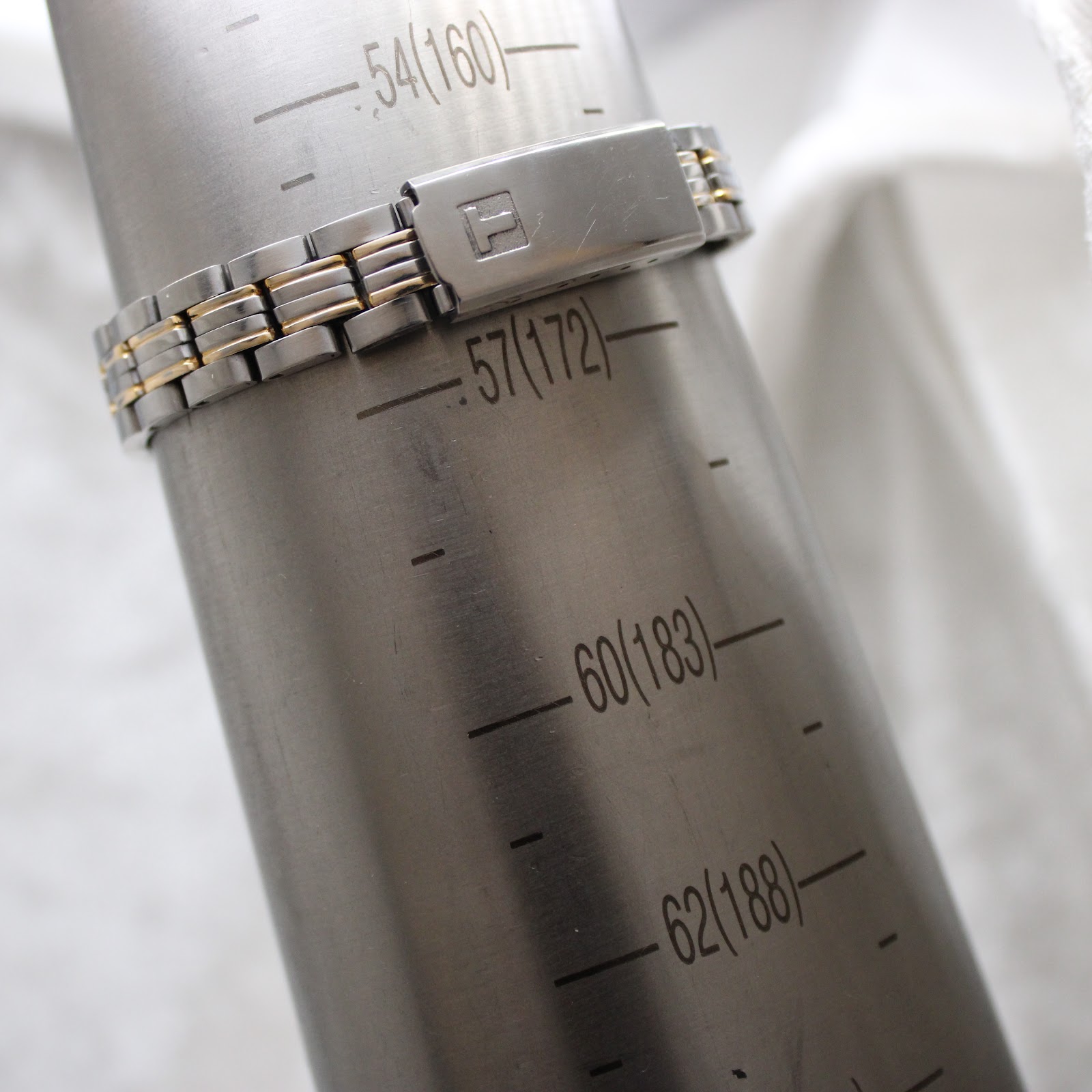 The Tissot PR 50 watch bracelet on a wrist sizing gauge, indicating an approximate wrist size of 172mm.