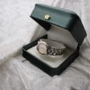 The Tissot PR 50 watch displayed inside a green generic watch box.
