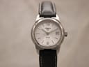 Front face of Tissot PR 50 watch with white dial and date window.